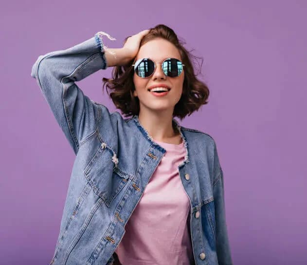 Woman in a denim jacket and sunglasses